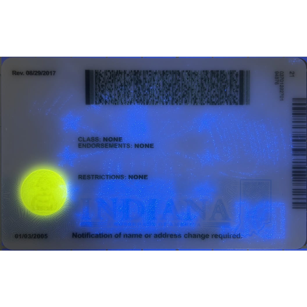 A close-up of a card or ID-style document with blue light-reactive markings, a barcode, and a bright yellow-green illuminated seal on the left side.